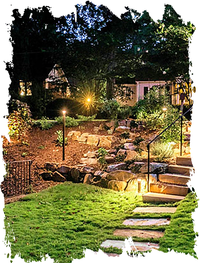 Finished landscape renovation featuring stone pathways and nighttime outdoor lighting in Druid Hills.