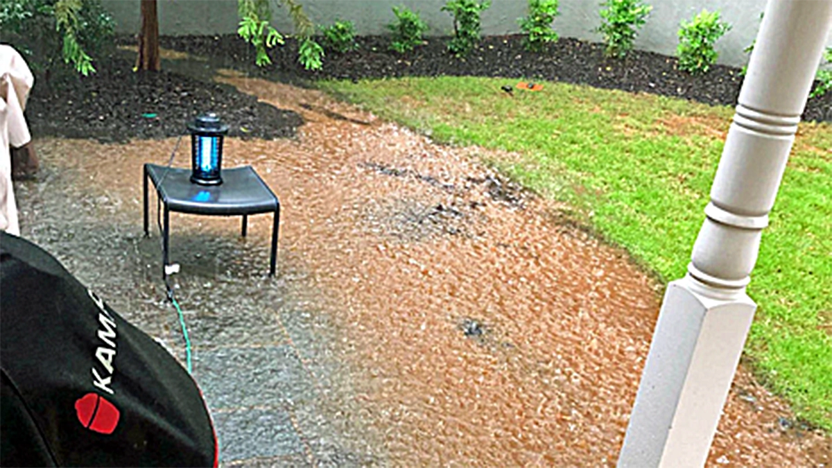A residential patio and lawn completely submerged under floodwater during a severe 5-inch rain storm in Atlanta.